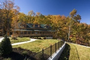 Fall colors in the trees behind A View is Forever cabin in the Smoky Mountains.