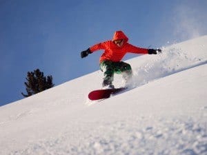 A snowboarder in the mountains.