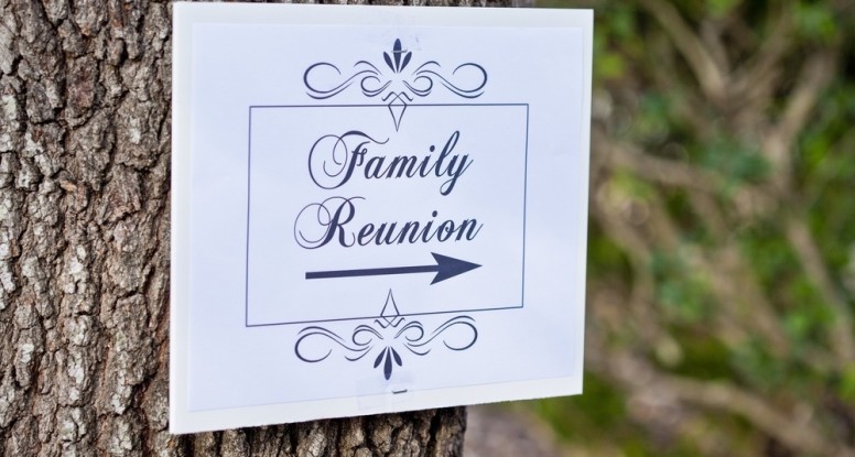 A sign on a tree pointing to a family reunion at our Smoky Mountain cabin resort.