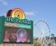 The Island sign with the Wheel in the background