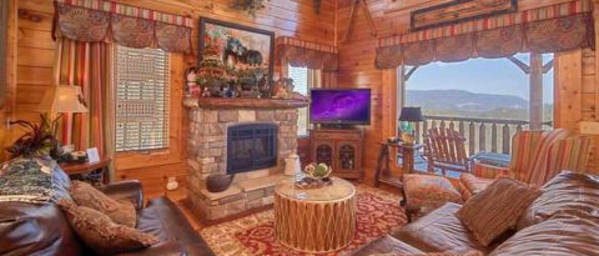living room with fireplace, tv, couches in a smoky mountain cabin for rent