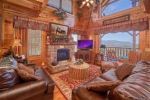 living room with fireplace, tv, couches in a smoky mountain cabin for rent