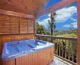 Hot tub outside cabin with mountain view